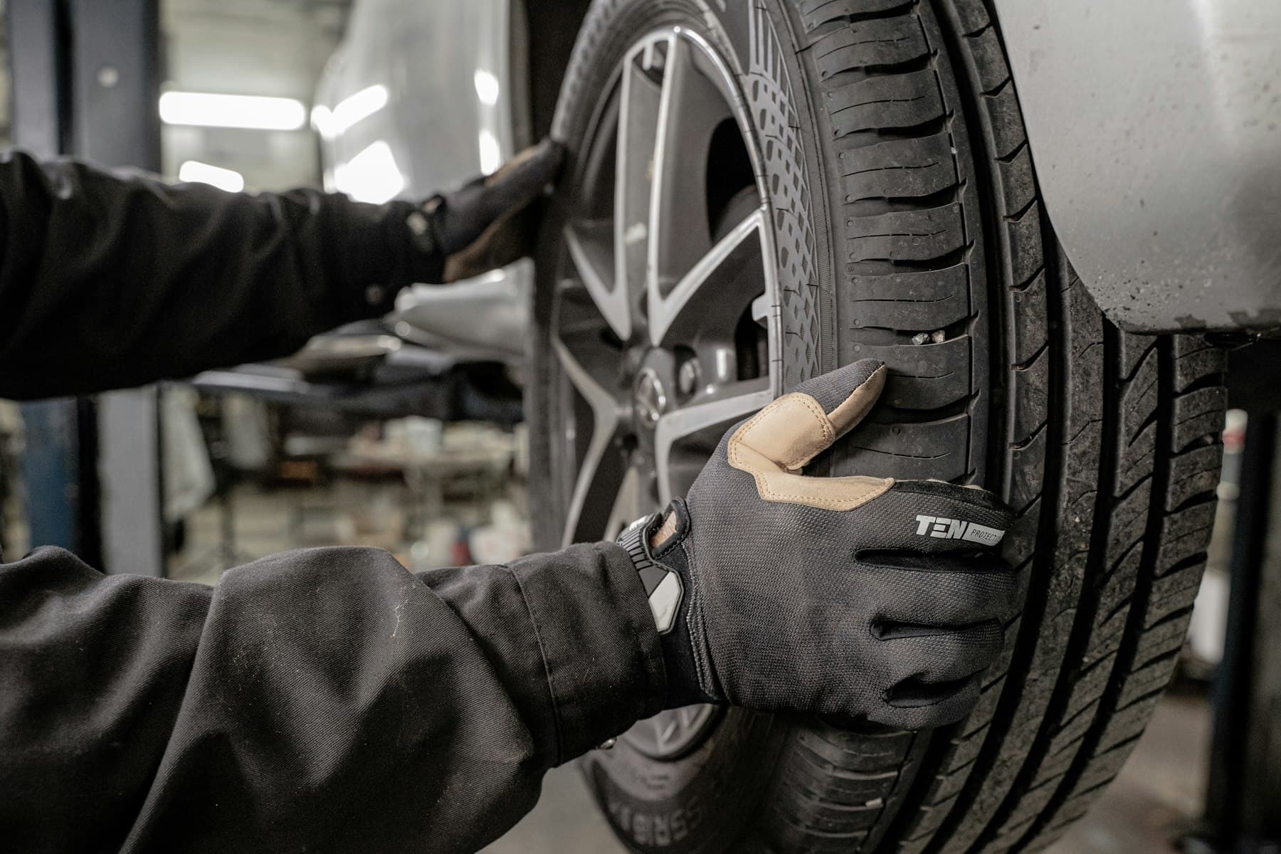 Mechanic inspecting a tire on a wheel